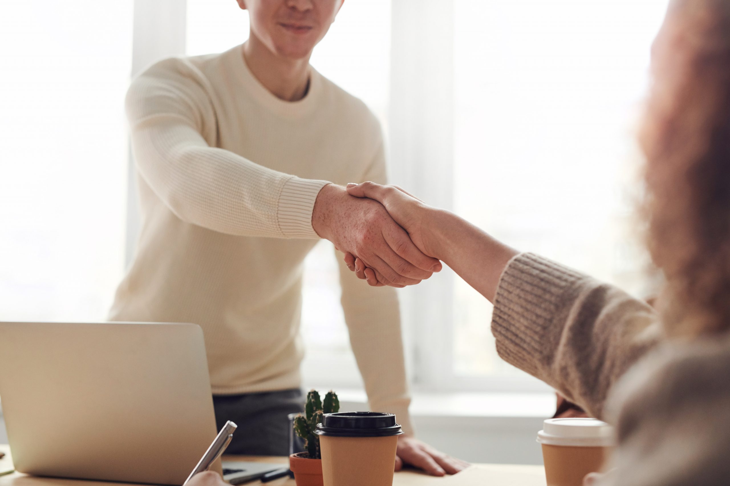 Dos personas dándose la mano gracias a las ayudas para contratar personal para autónomos